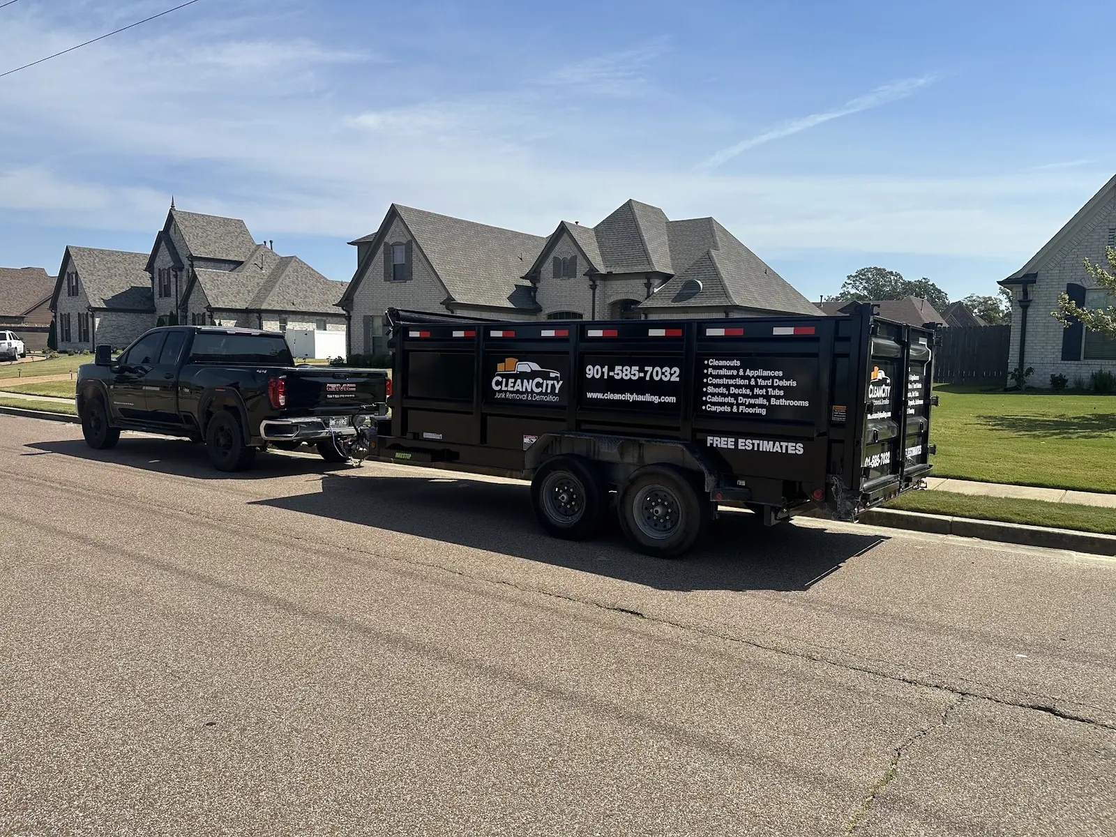 Clean City pickup and dump trailer parked on a residential street