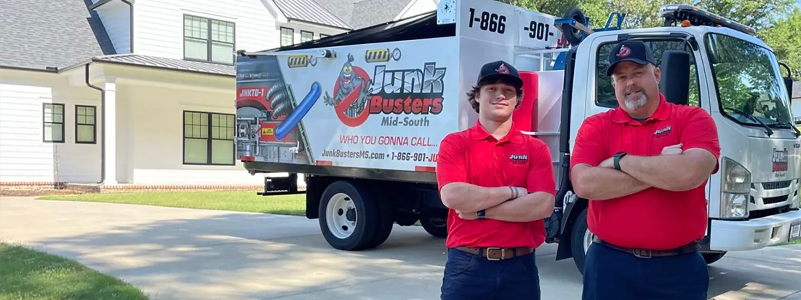Junk Busters crew members standing by the truck