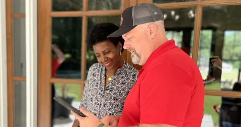 A Junk Busters crew lead pricing a job with a homeowner