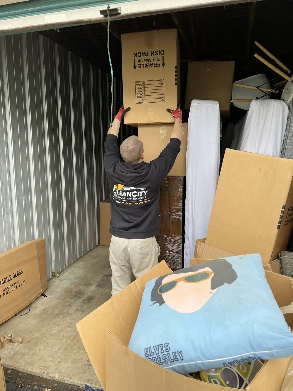 A crew member pulling boxes out of a storage unit